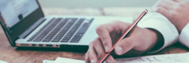 Work desk with business broker writing a valuation