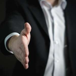 Man in suit putting out hand for a handshake in Thousand Oaks, California