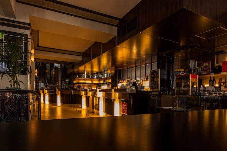 Dark modern bar with orange lighting in Los Angeles, California.